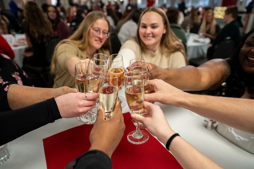 Graduates toasting champagne at Senior Toast